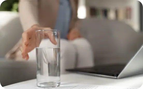 close-up-woman-therapist-reaching-glass-water